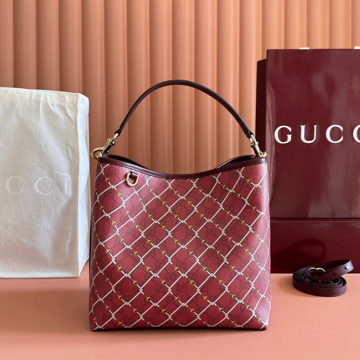 GUCCI 26S  EMBLEM BUCKET BAG 25 IN DARK RED COATED FABRIC